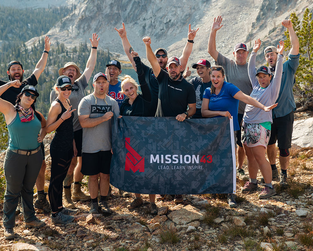 mission 43 team holding flag and cheering